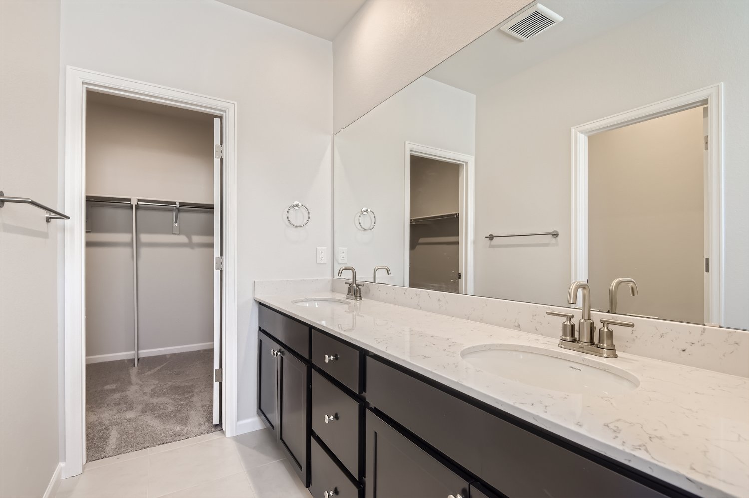 A bathroom with a large mirror.