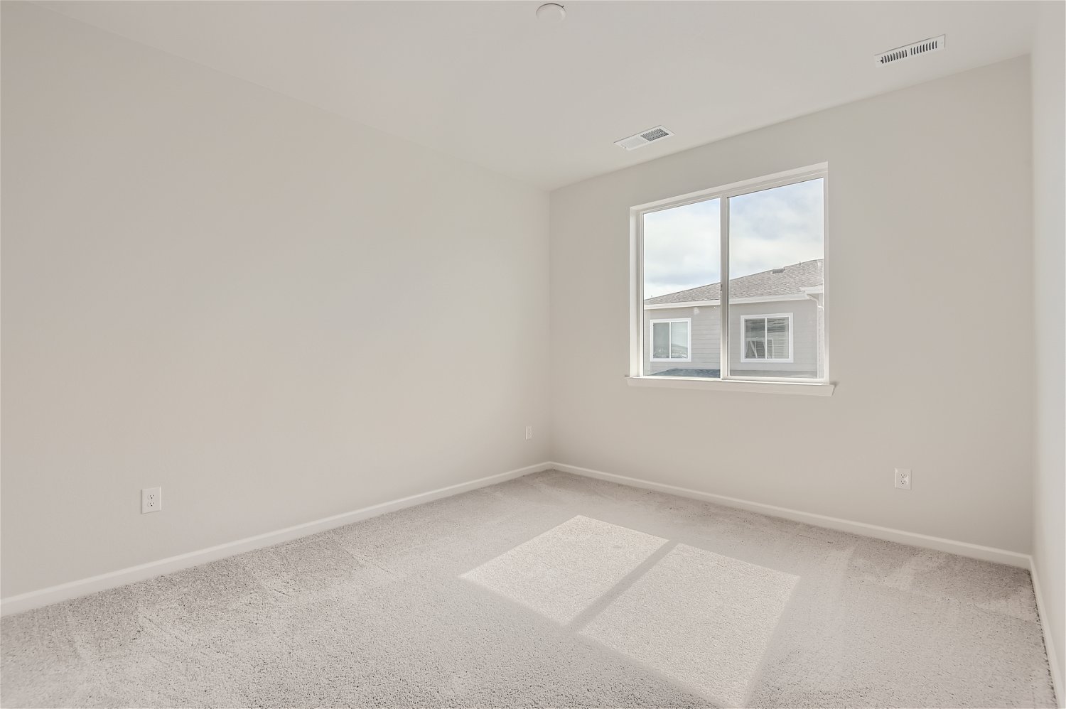 A room with a window and a tile floor.