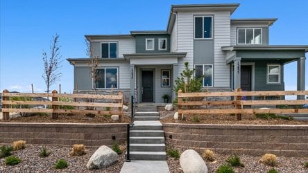 A house with a fence and stairs.