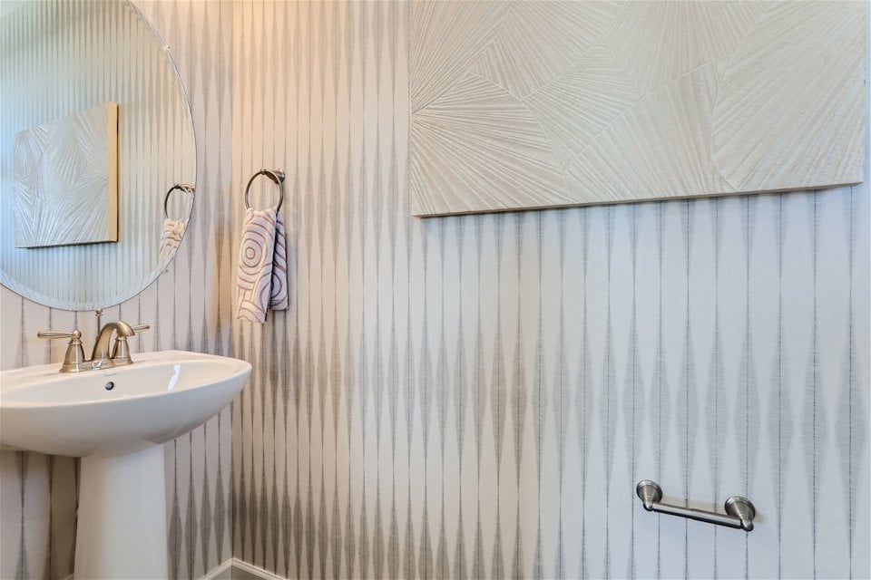 A bathroom with a mirror and sink.