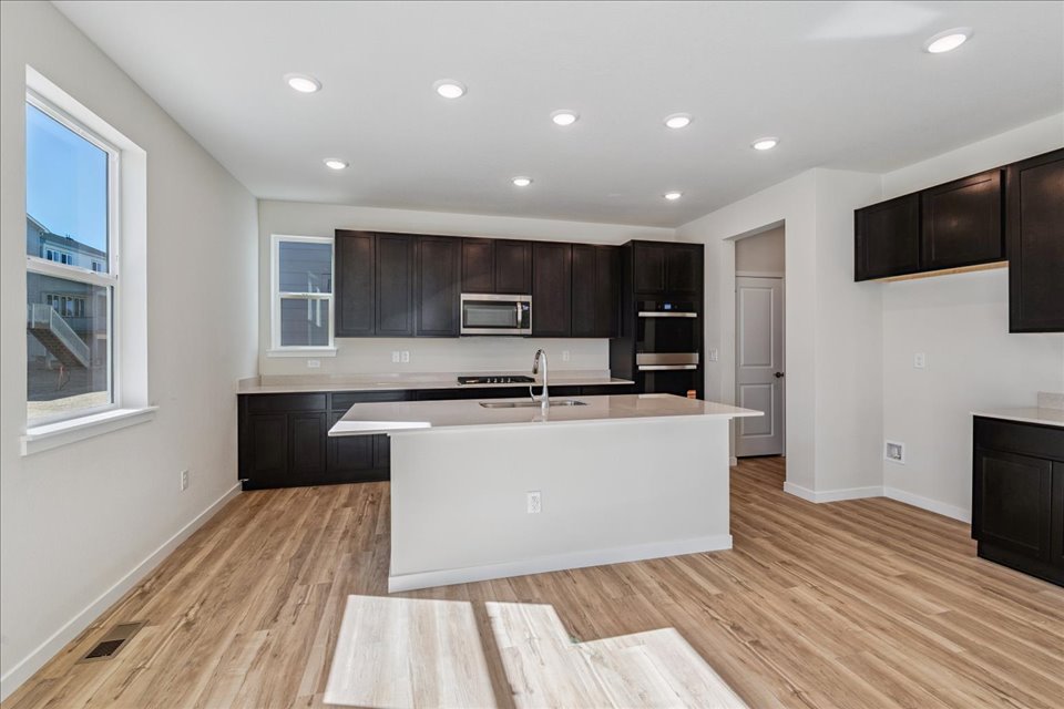 A kitchen with a wood floor.