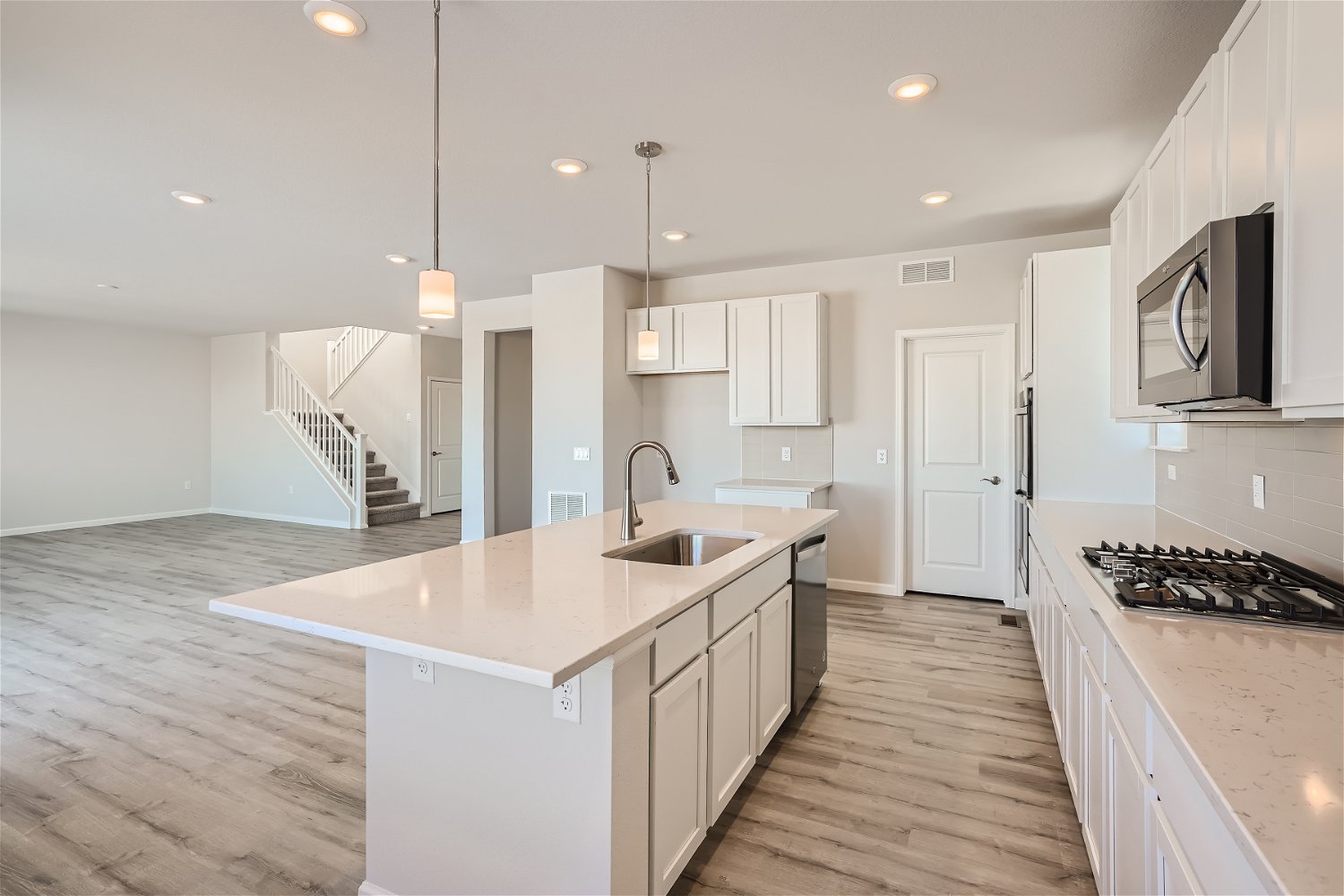 A kitchen with white cabinets.