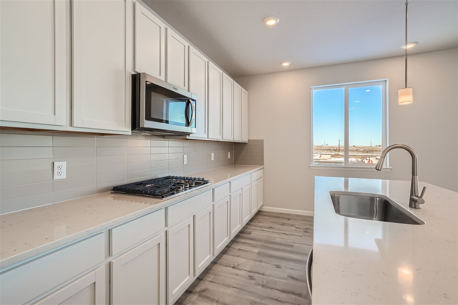 A kitchen with white cabinets.
