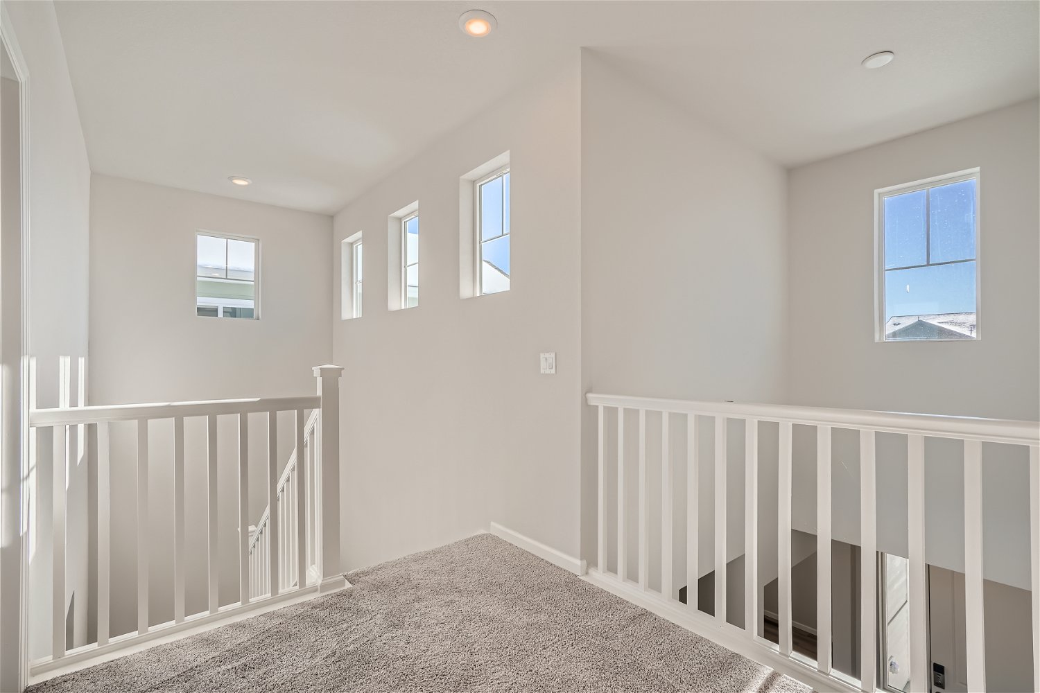 A white room with a white railing.