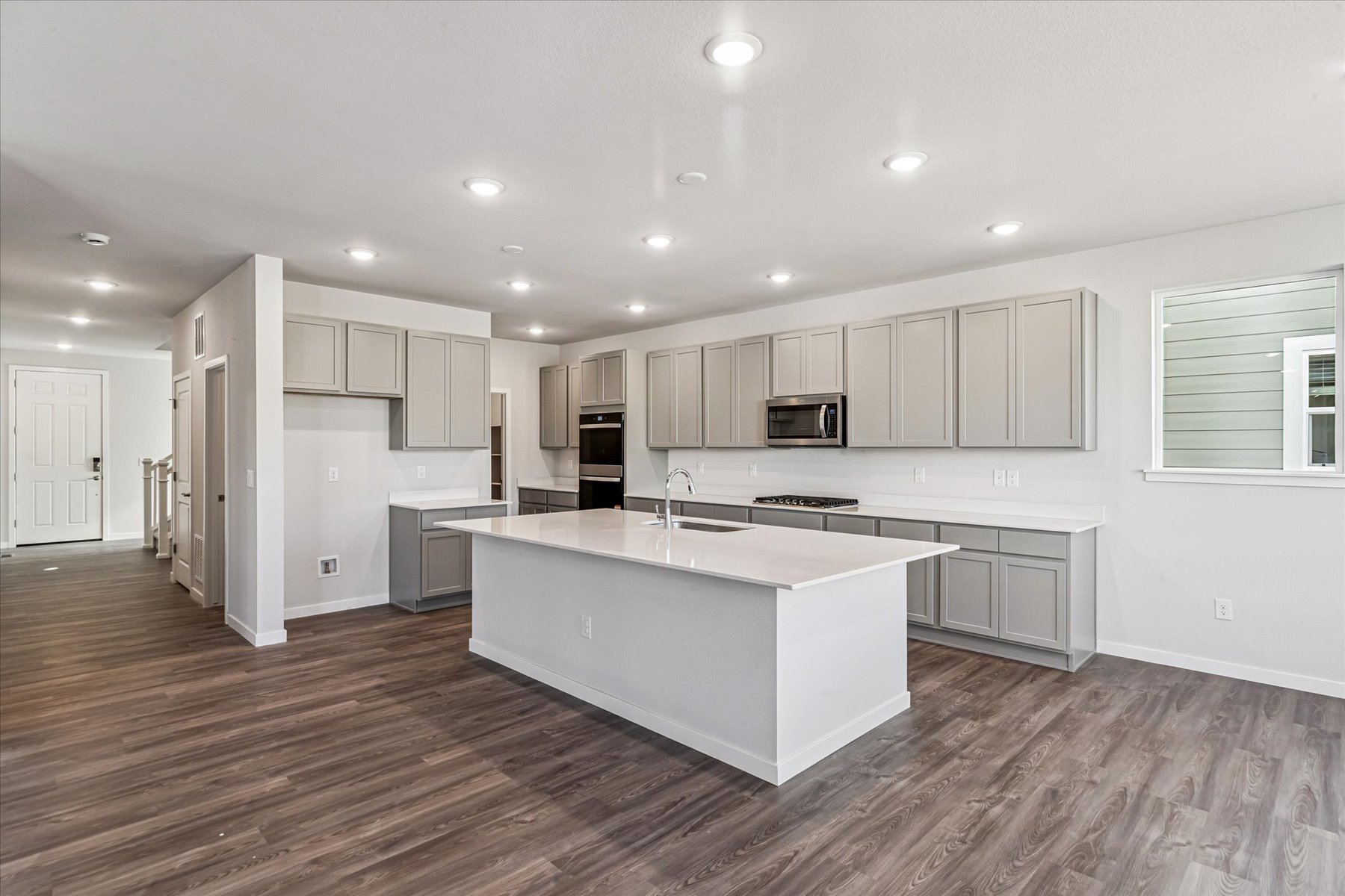A kitchen with white cabinets.