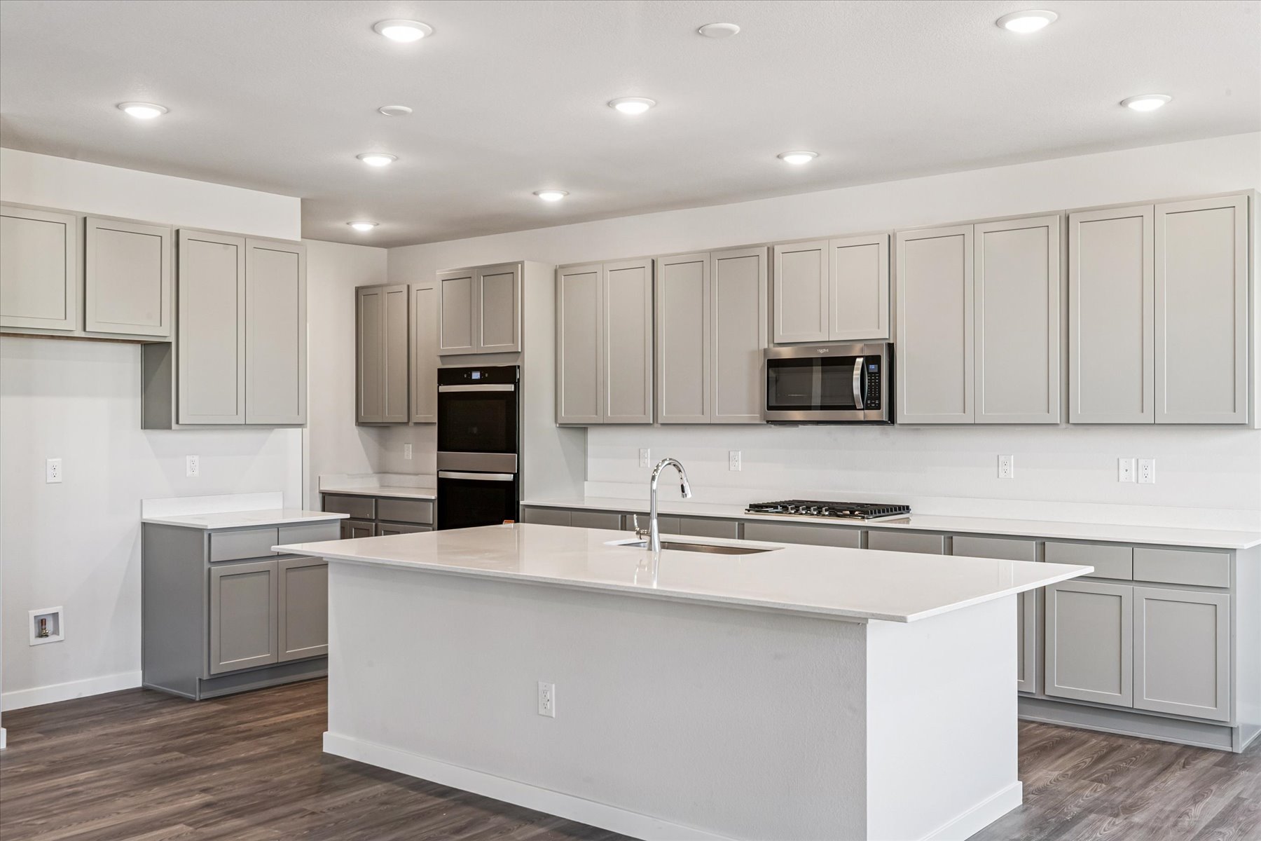 A kitchen with white cabinets.