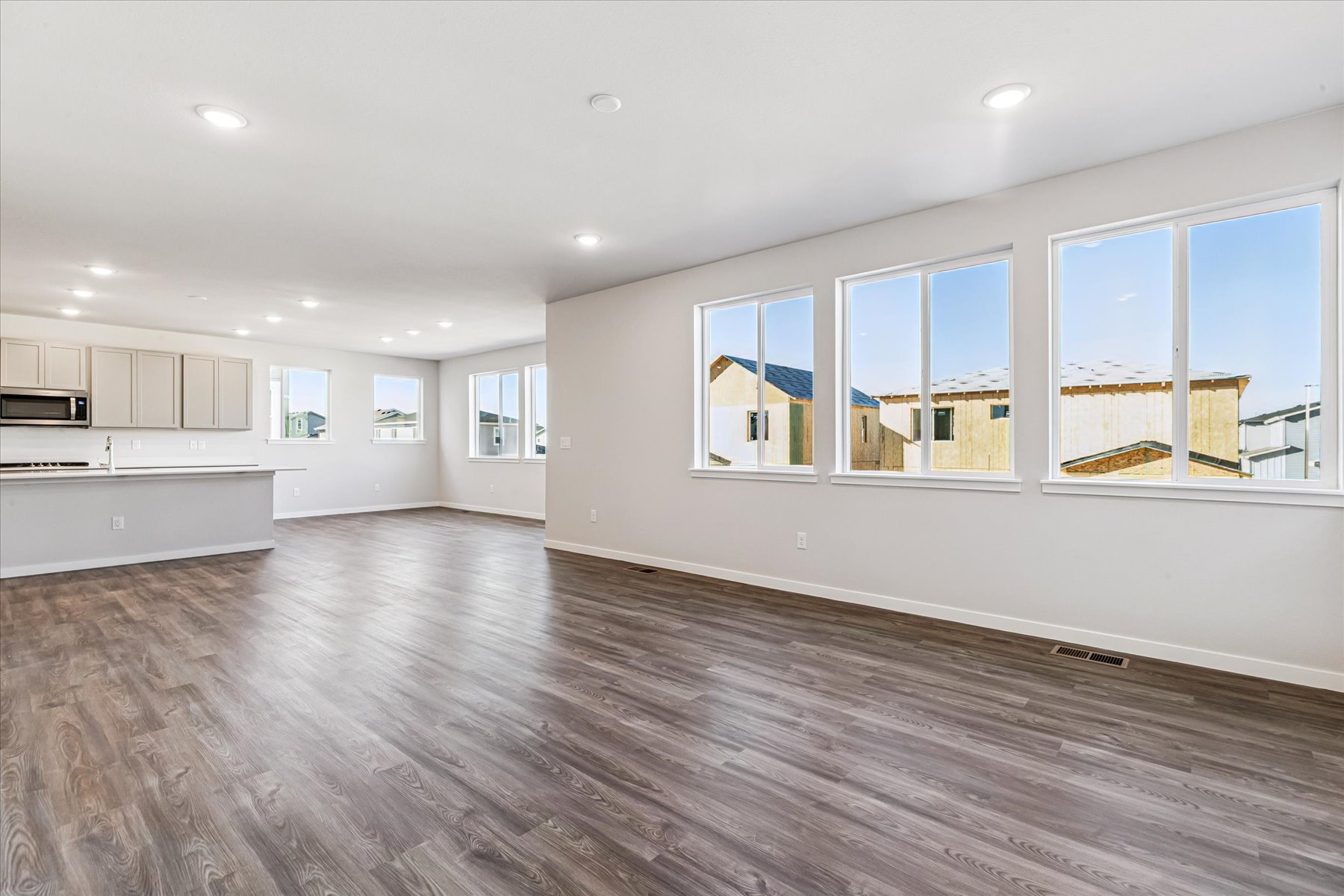 A large empty room with large windows.