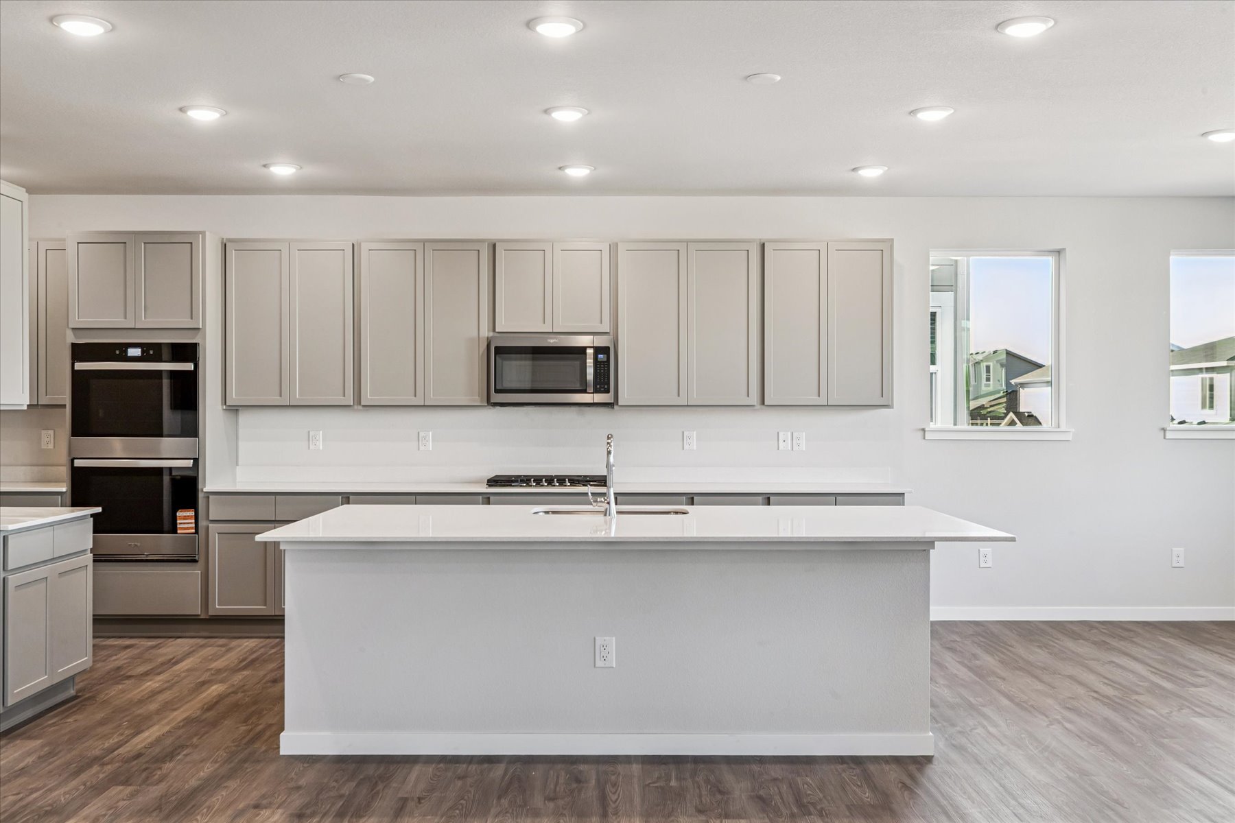 A kitchen with white cabinets.