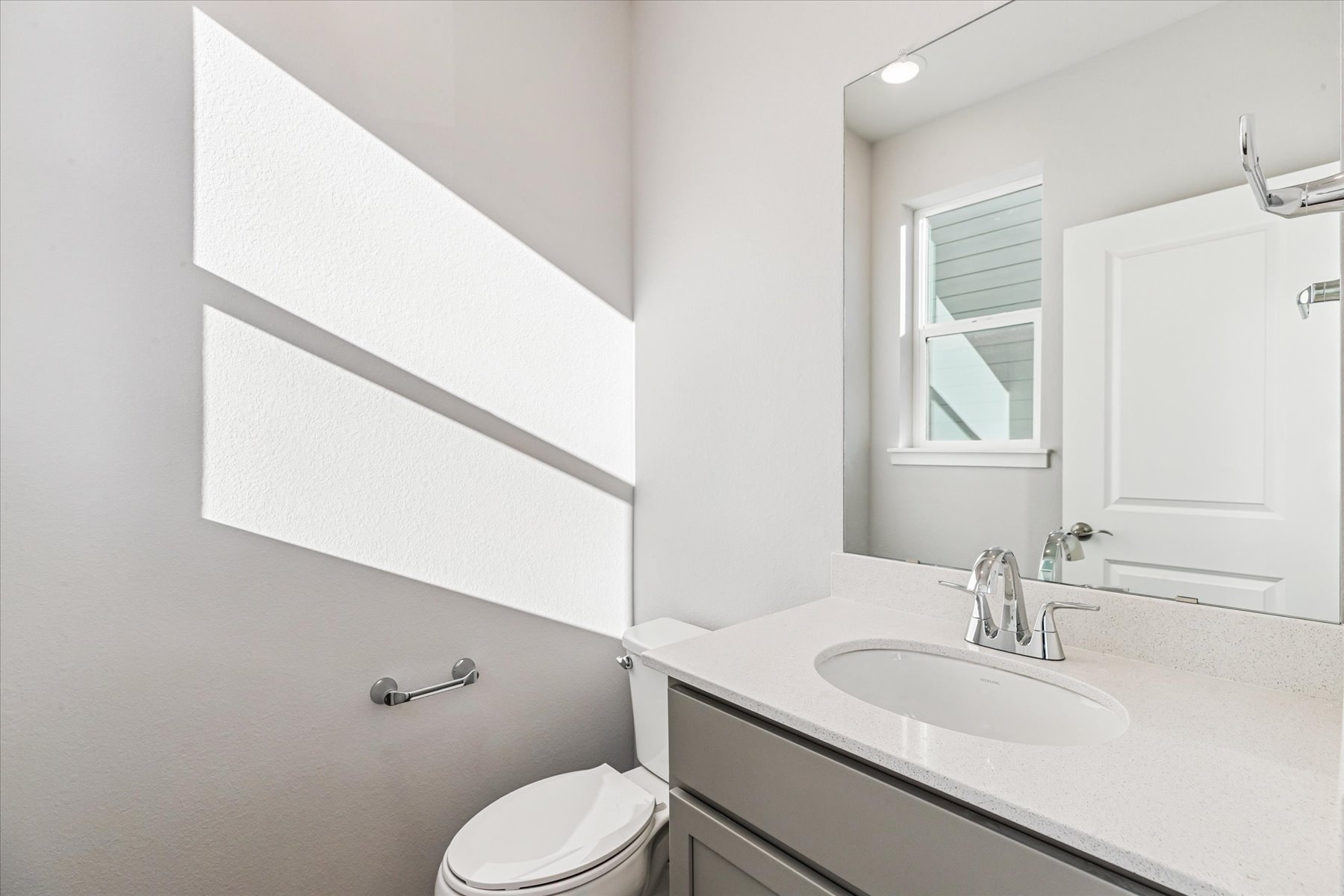 A bathroom with a sink and a toilet.