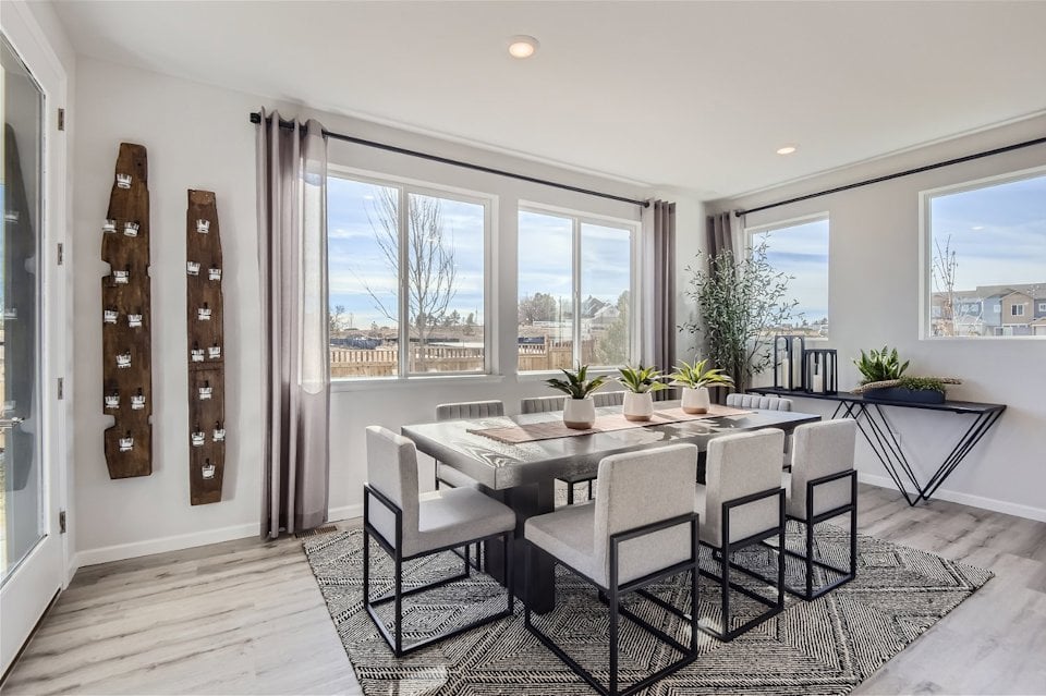 A dining room with a large window.