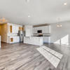 Great room and kitchen of the ranch style Palisade plan by Century Communities