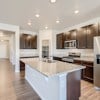 Open concept kitchen and hallway of the ranch style Telluride plan by Century Communities