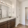 Owner's private bath with dual vanity and walk in closet of the ranch style Telluride plan by Century Communities