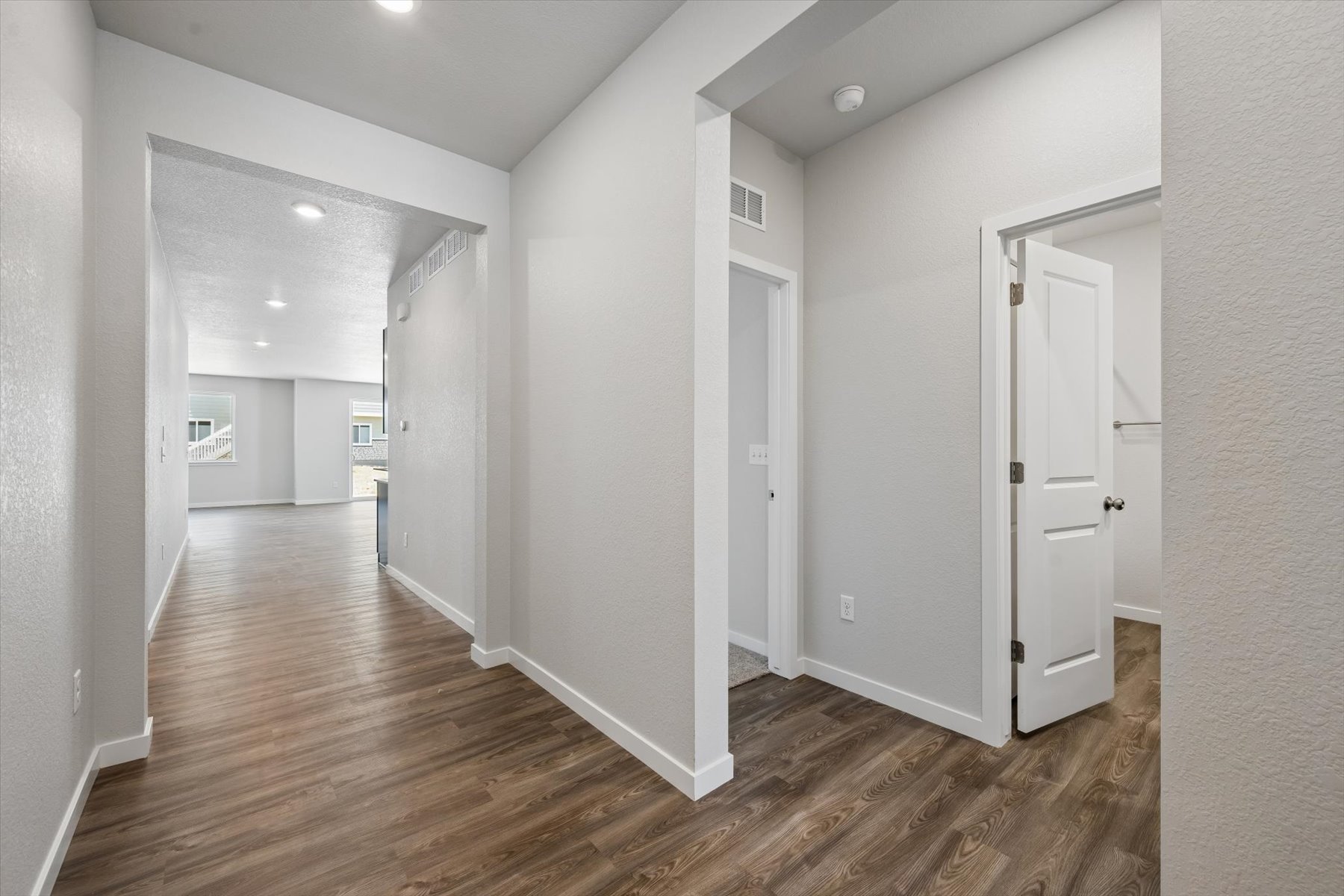 A hallway with white doors.