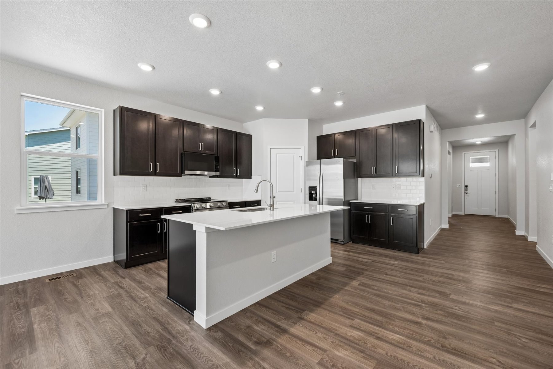 A kitchen with black cabinets.