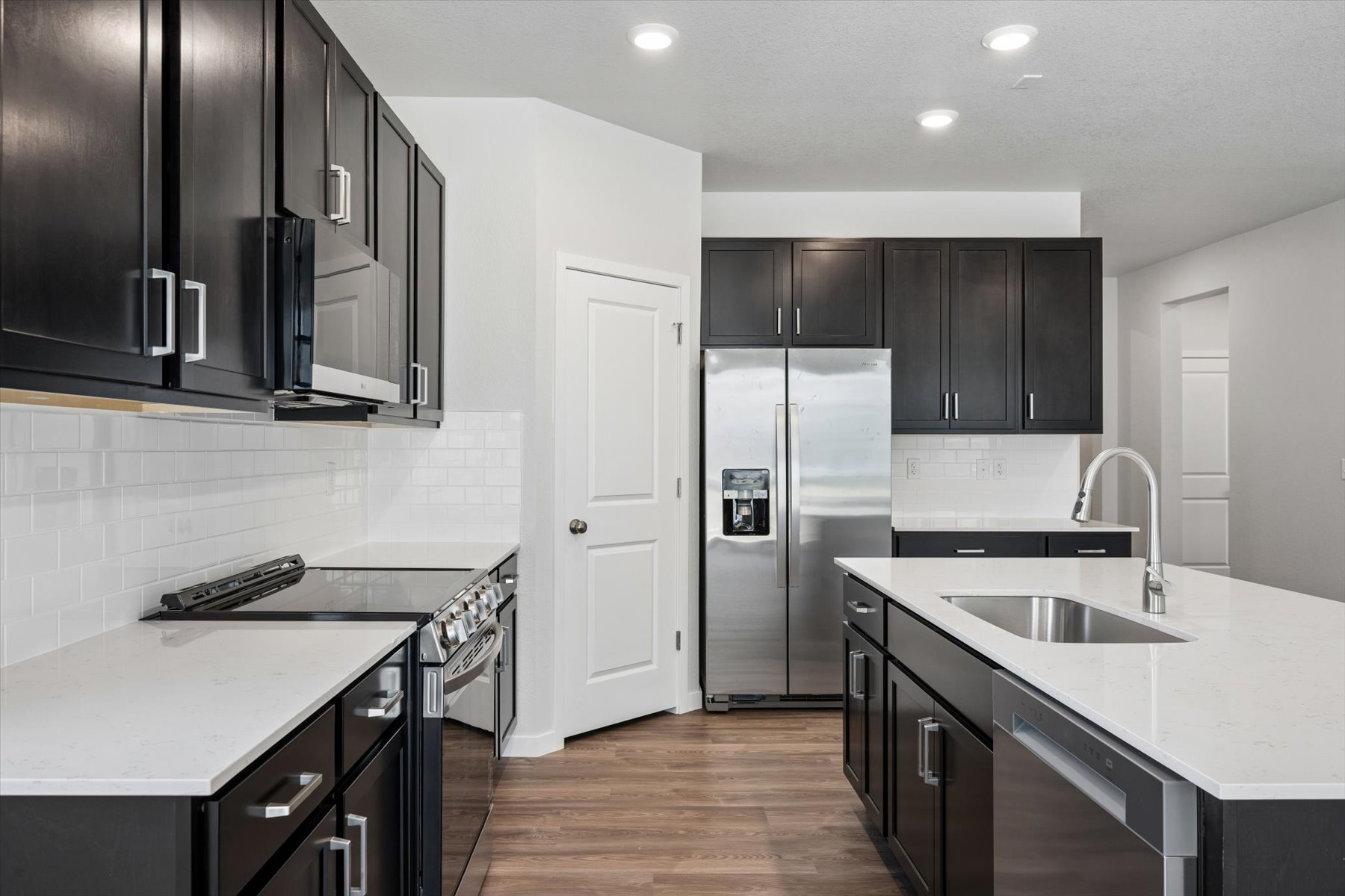 A kitchen with black cabinets.