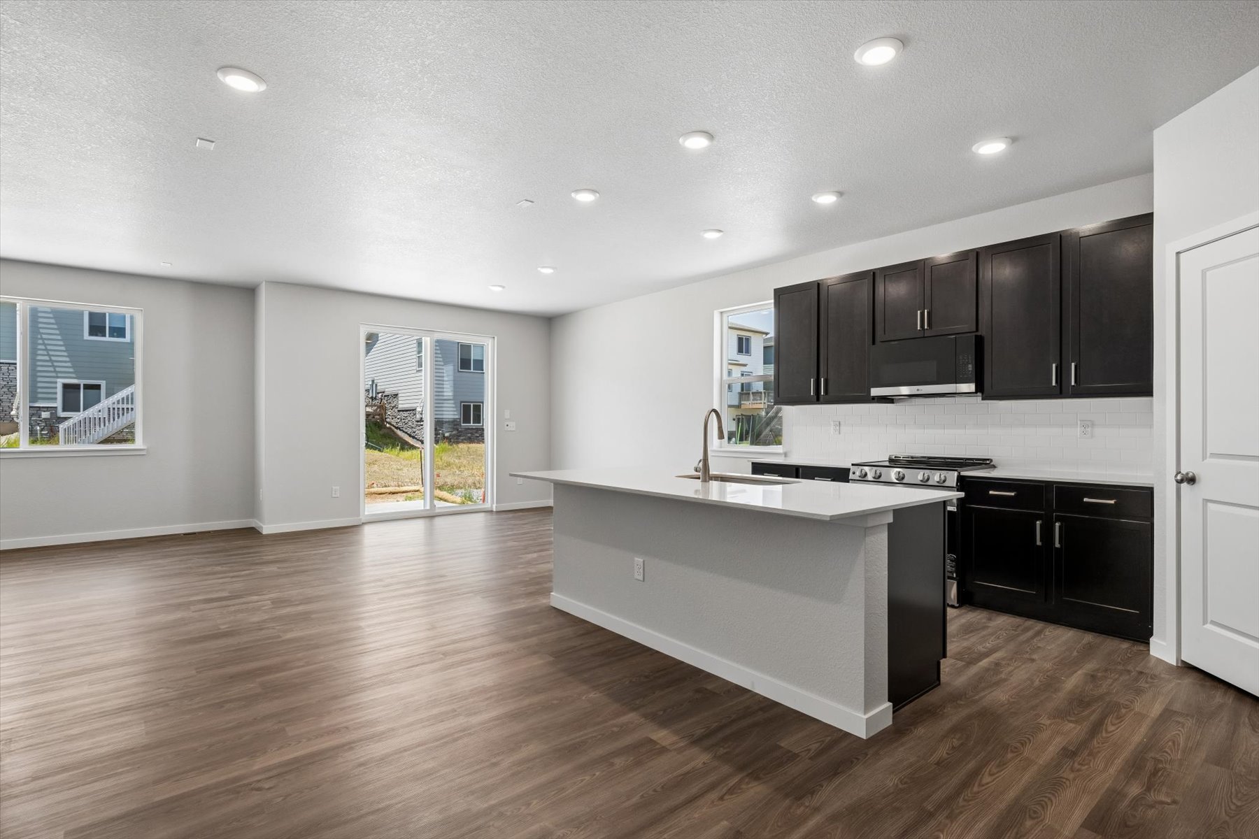 A kitchen with black cabinets.