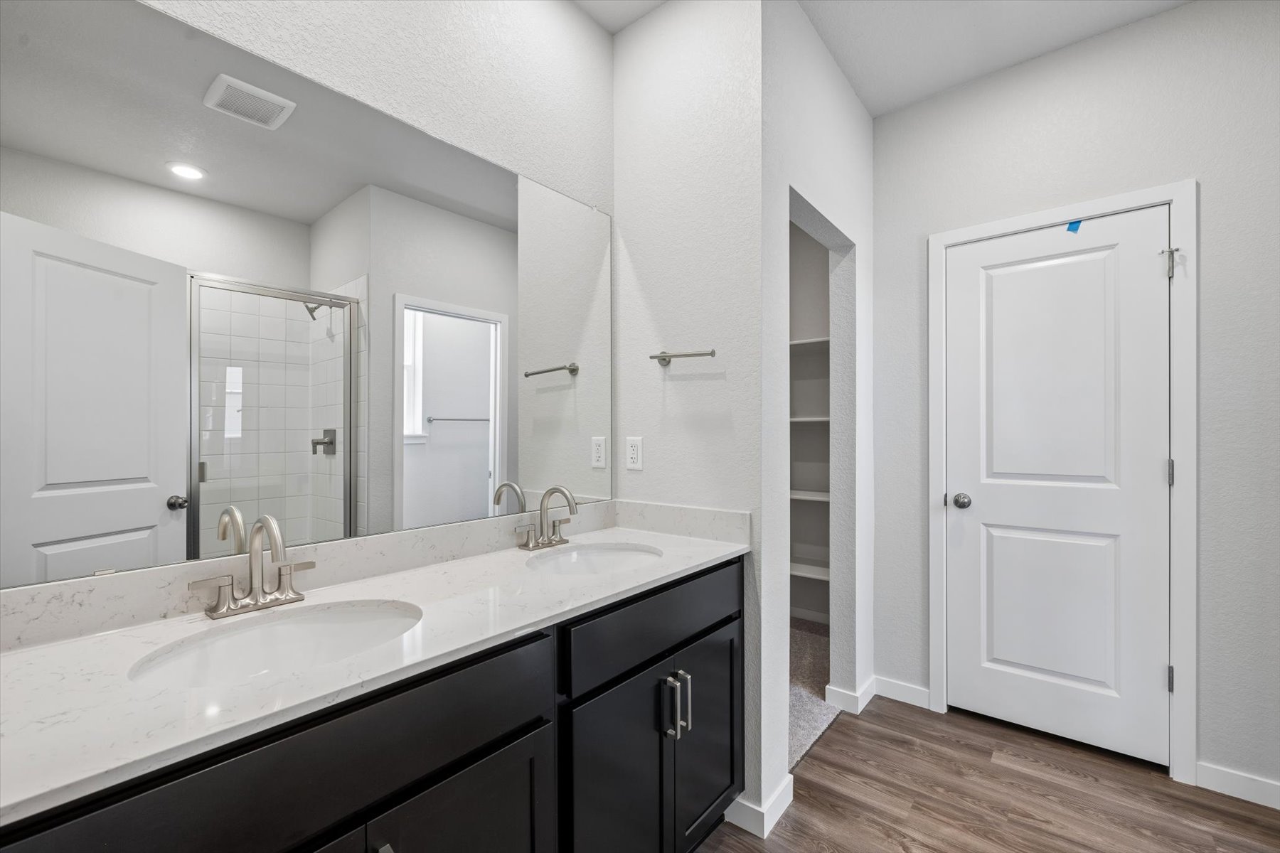 A bathroom with a large mirror.