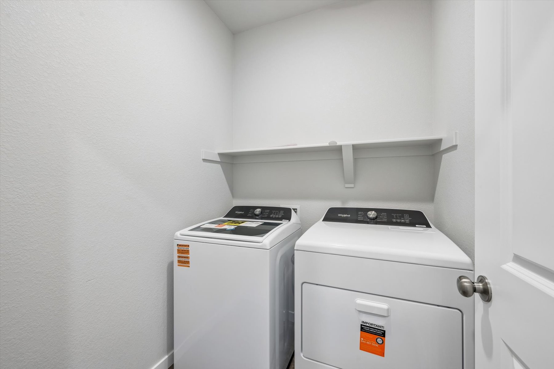 A small kitchen with a washer and dryer.
