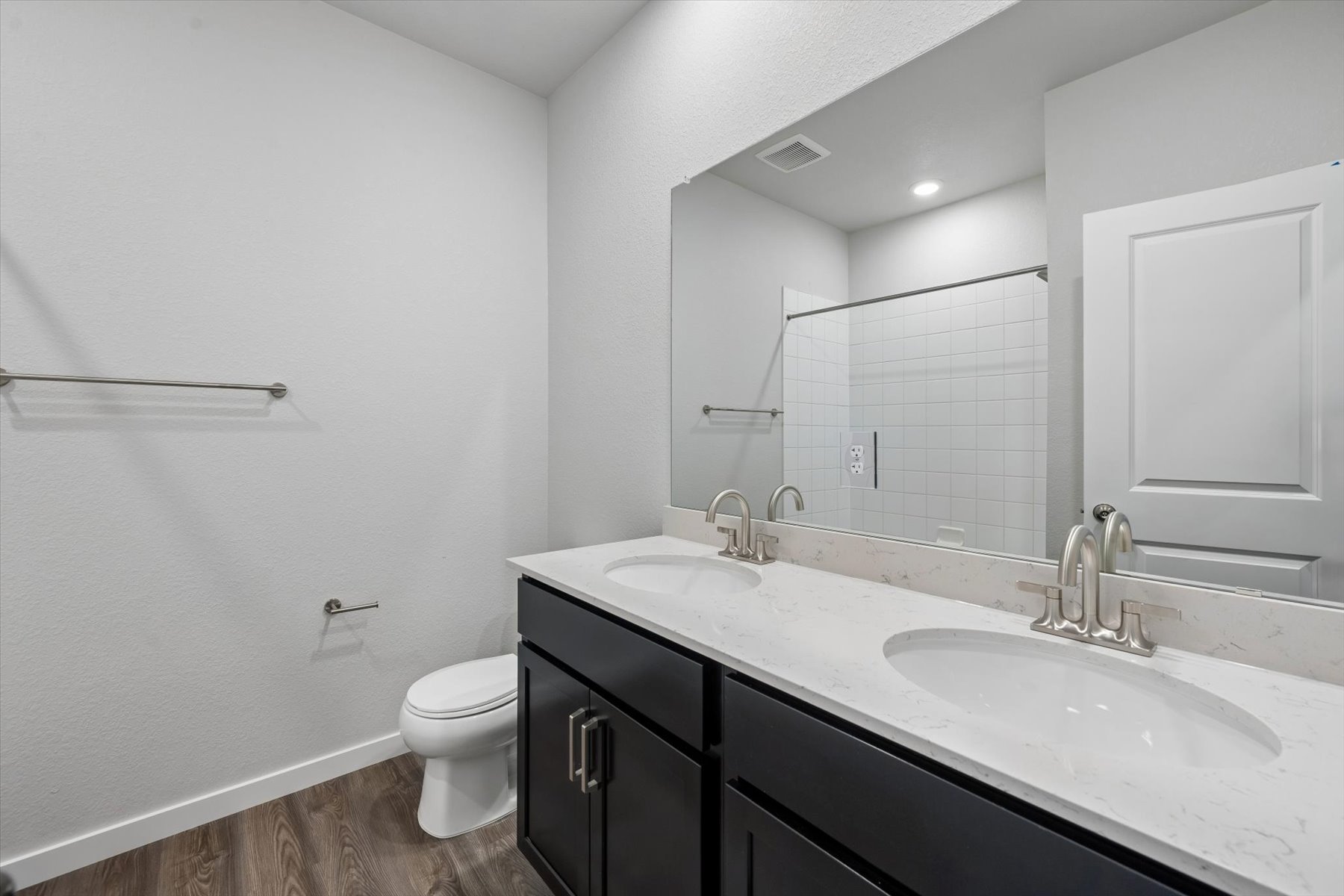 A bathroom with a large mirror.