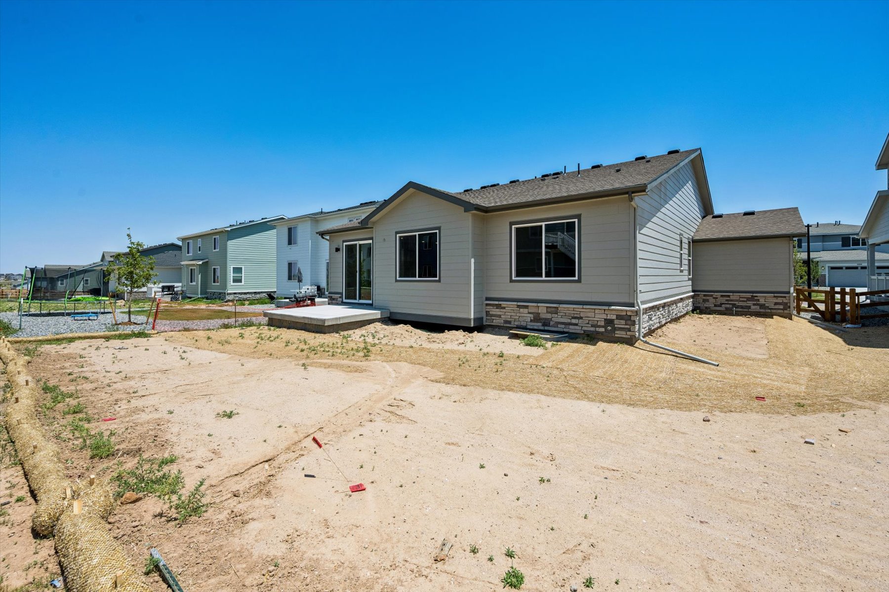 A house with a dirt yard.