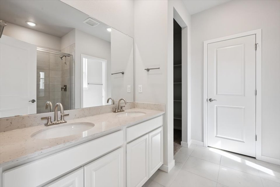 A bathroom with a large mirror.