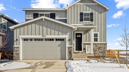 A white house with a garage.