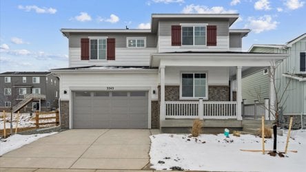A white house with a garage.