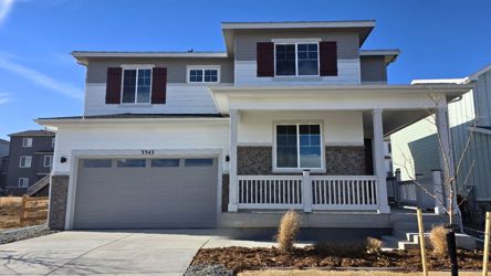 A white house with a garage.