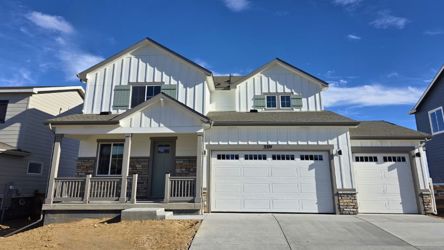 A white house with garages.