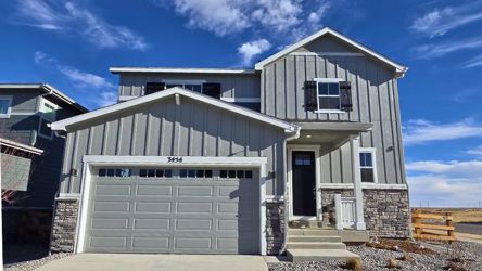 A white house with a garage.