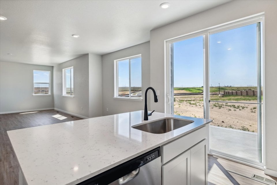 A kitchen with a sink and a large window.