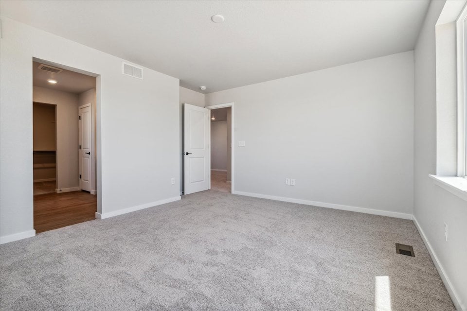 A hallway with white walls.
