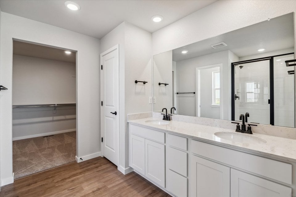 A bathroom with white cabinets.