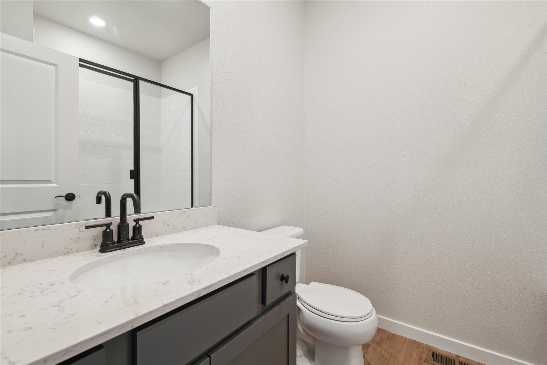 A bathroom with a sink and a toilet.