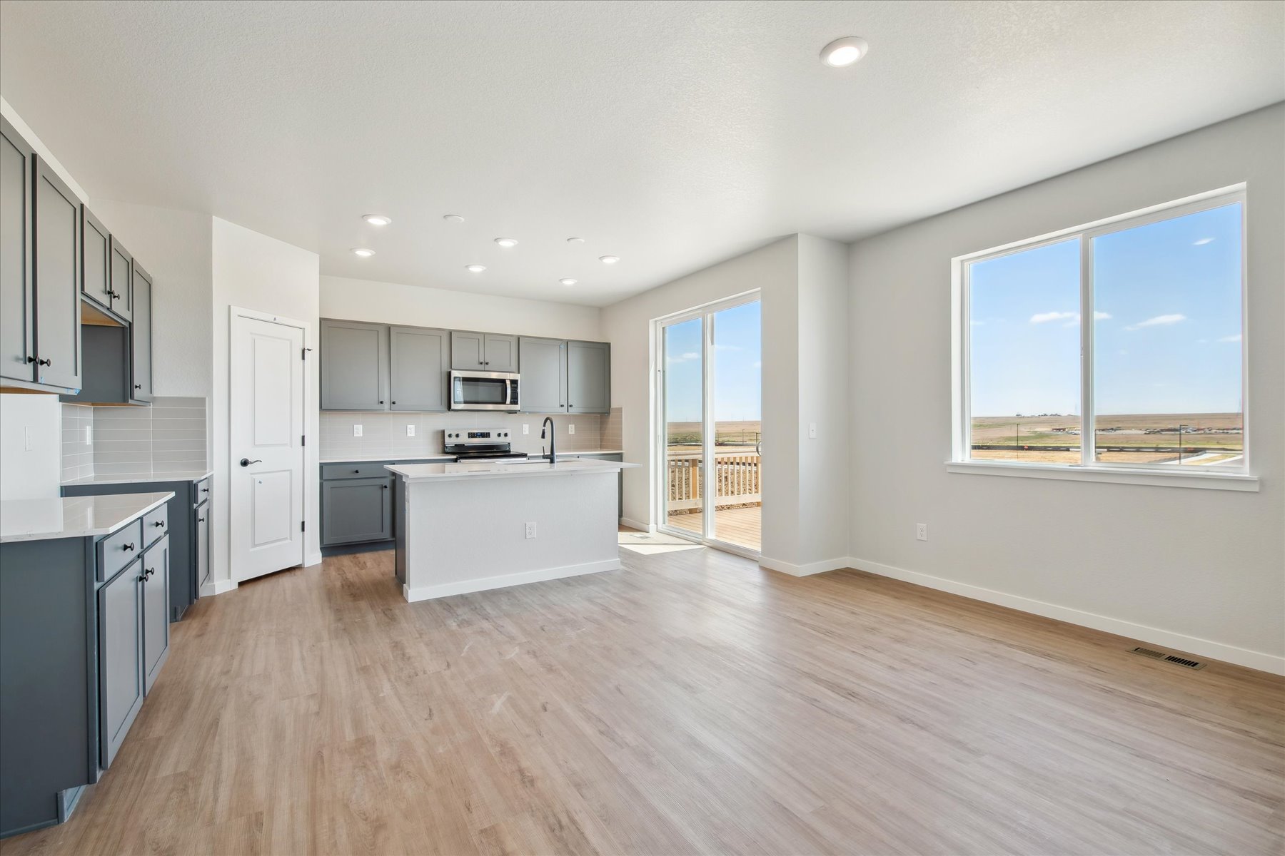 A large kitchen with black cabinets.