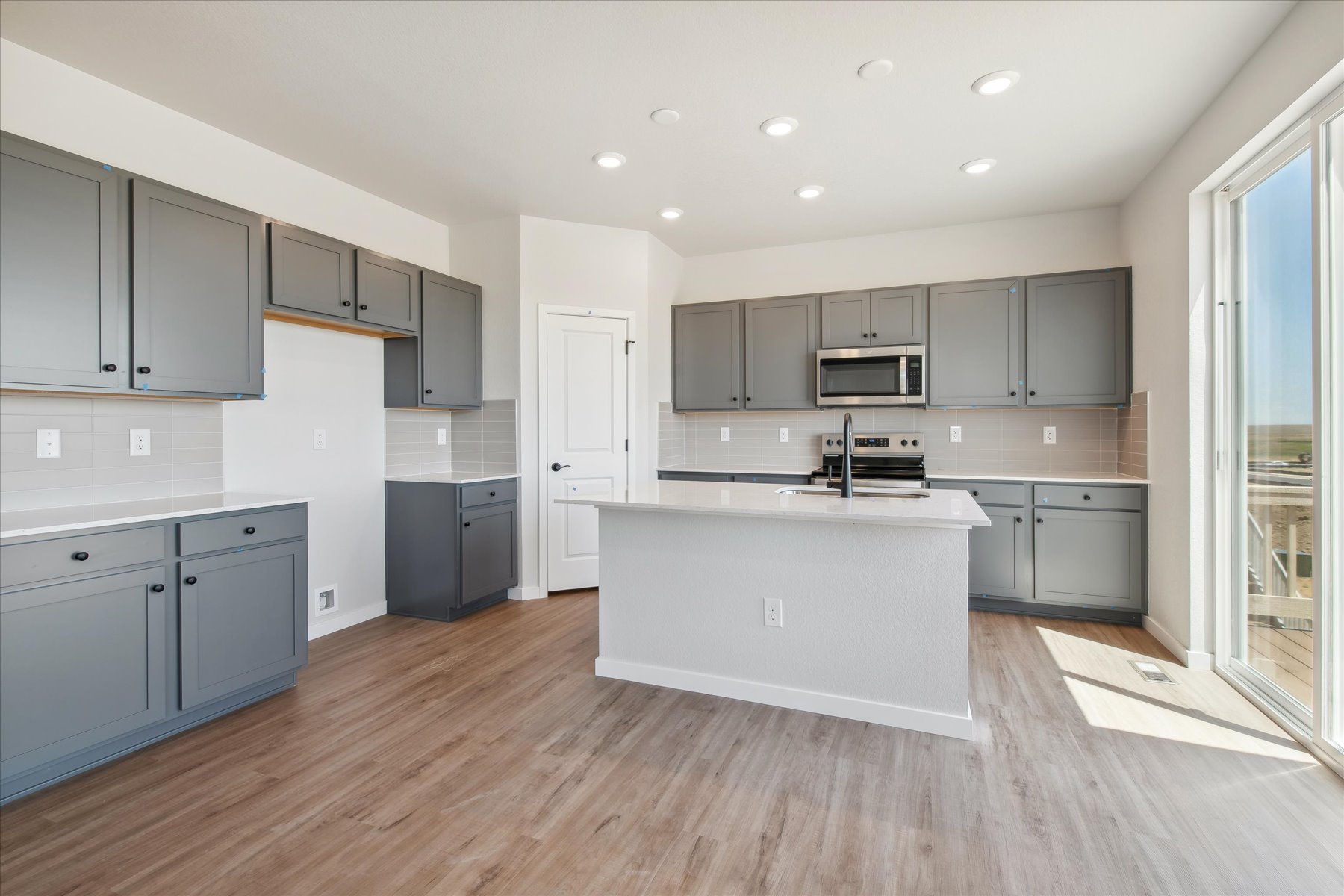 A kitchen with white cabinets.