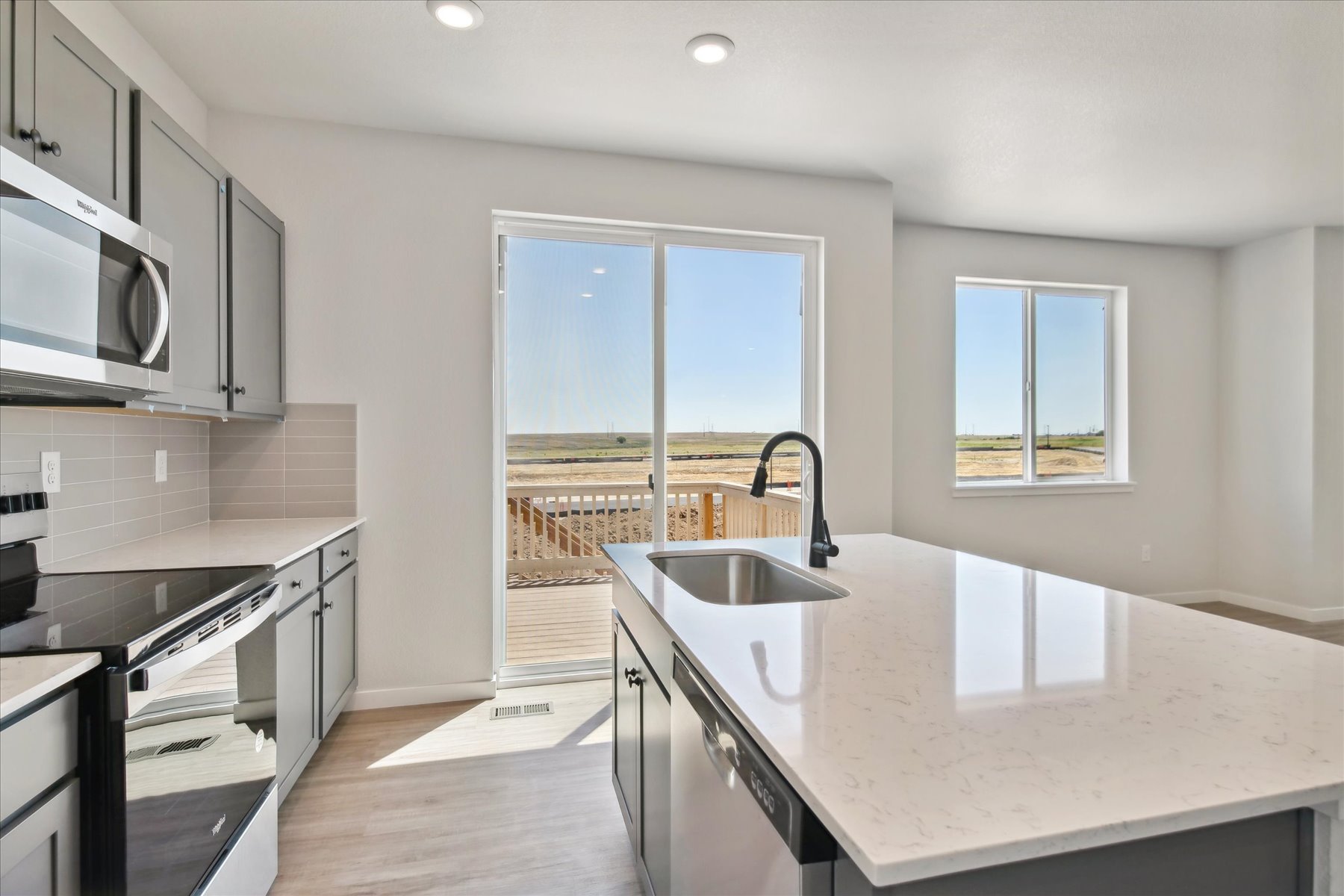 A kitchen with a large window.