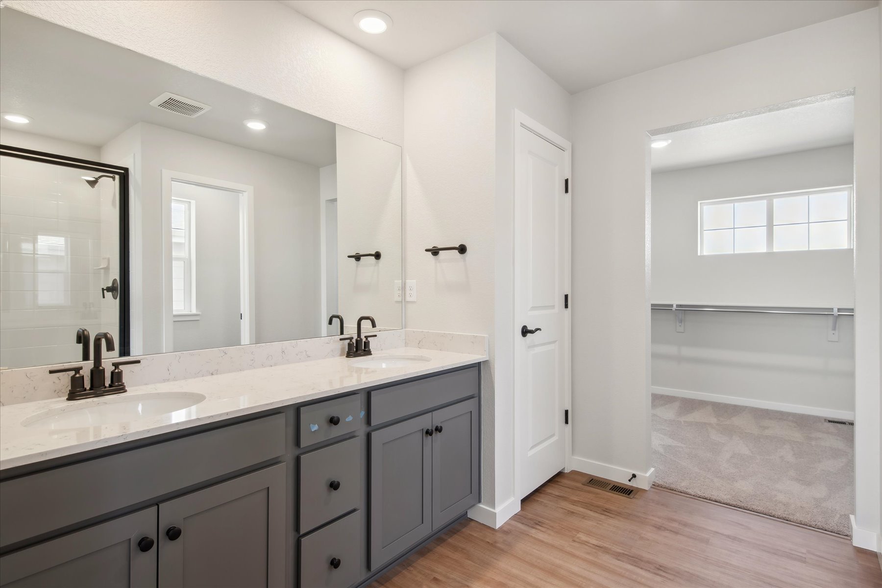 A bathroom with a tub sink and mirror.