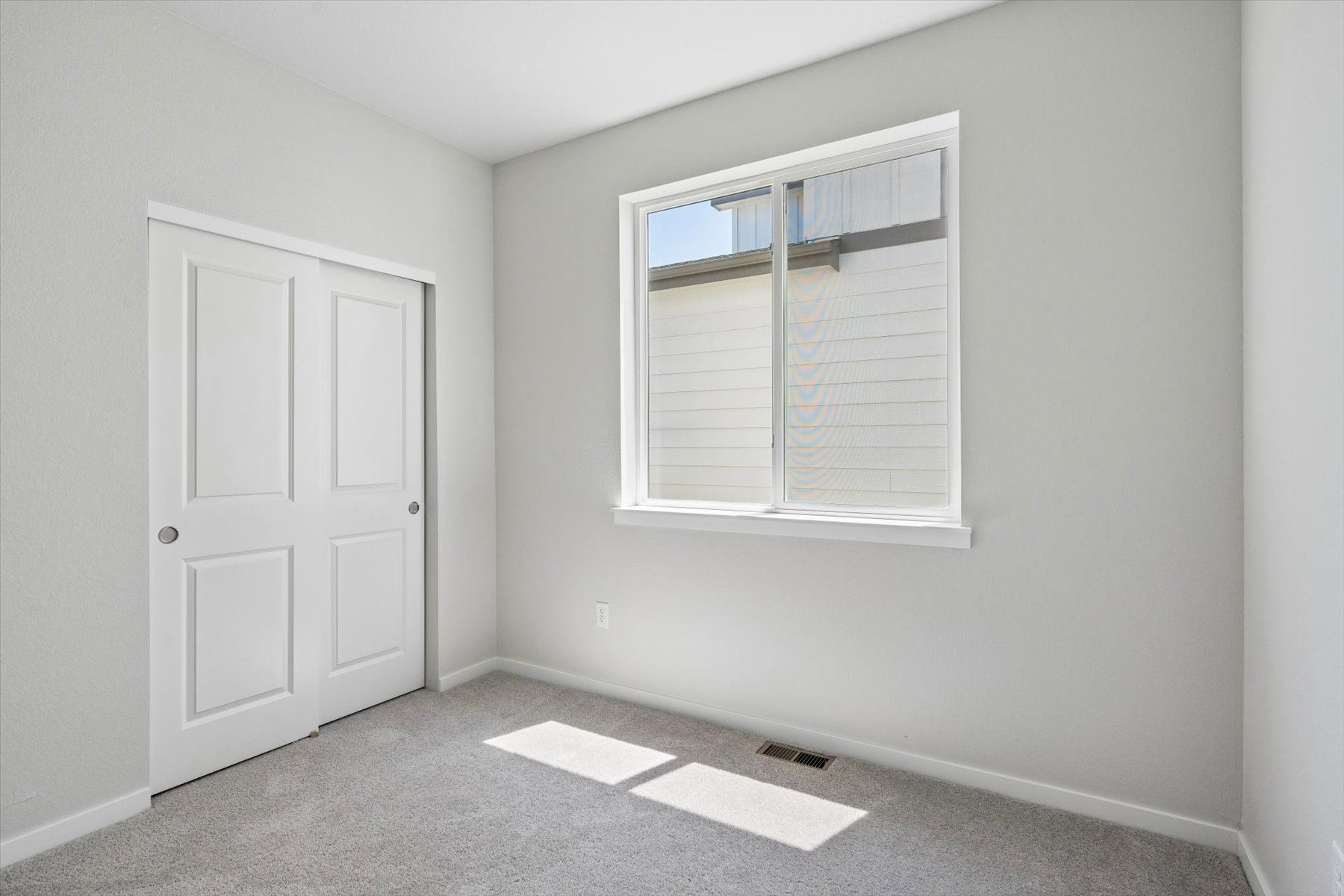 A room with white doors and a window.
