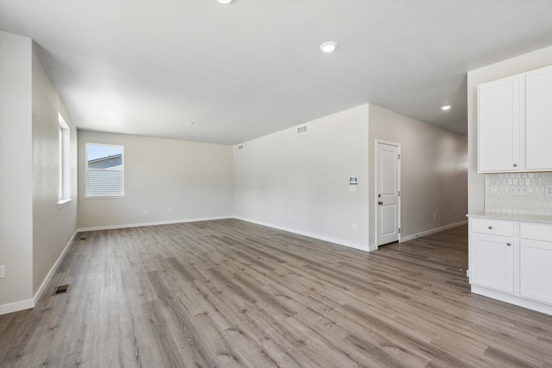 A room with white cabinets.