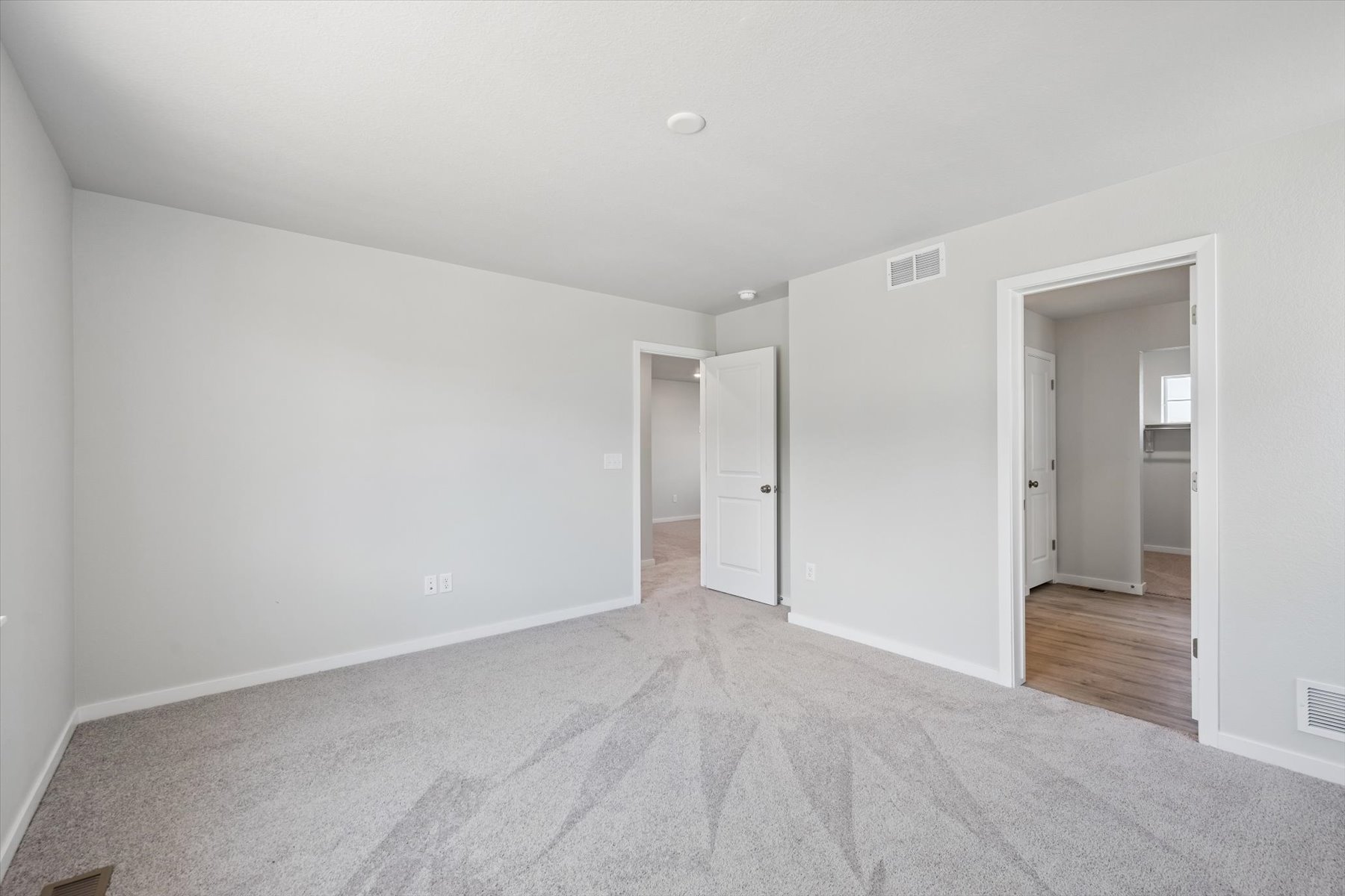 A hallway with white walls.