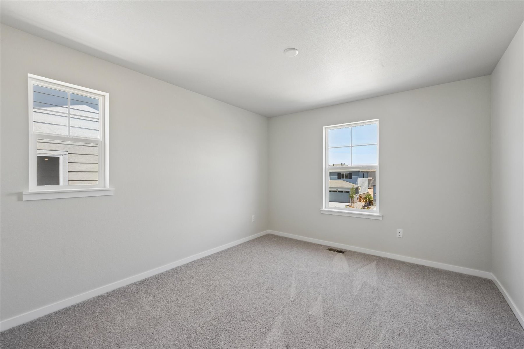 A room with a window and a carpet.