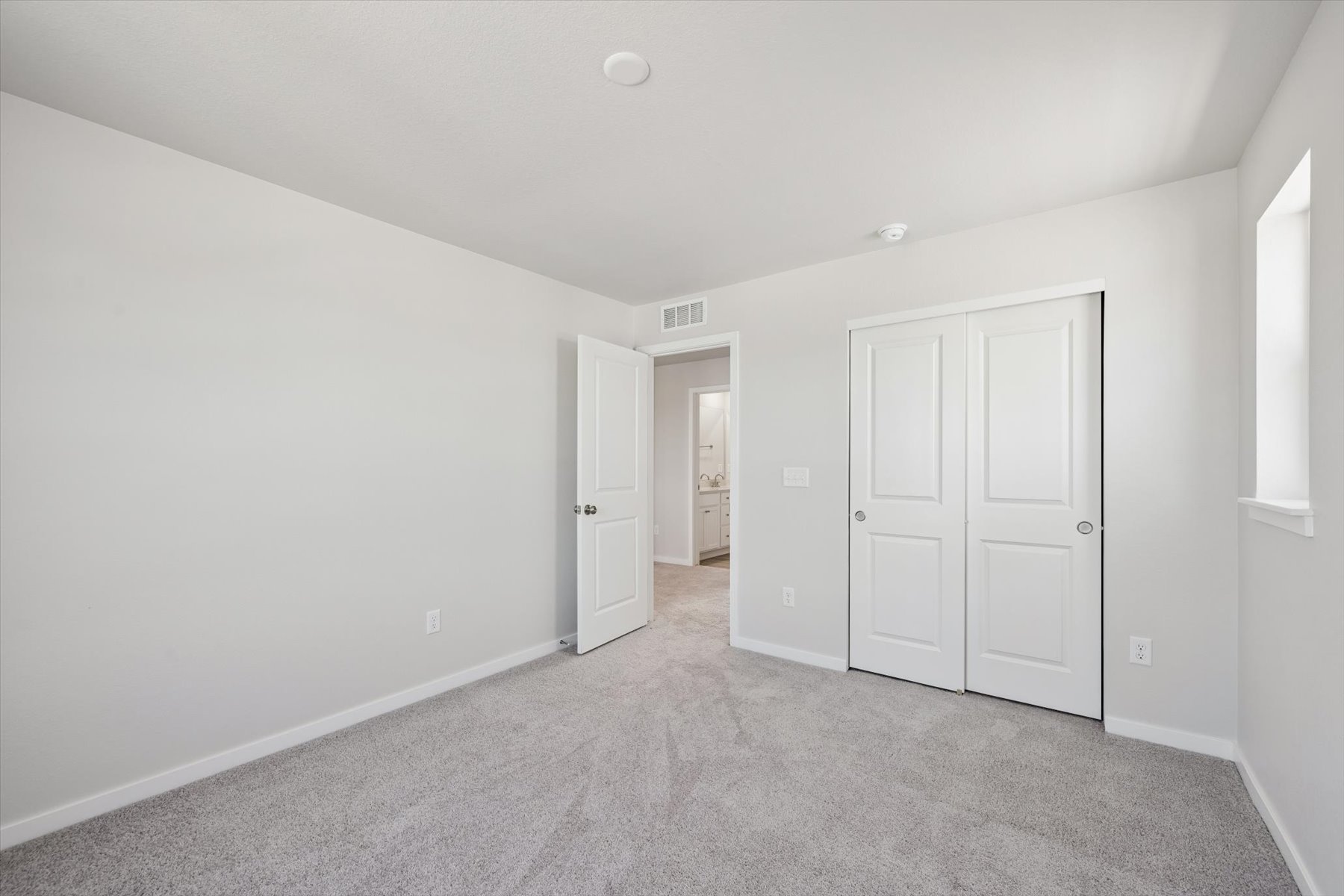 A hallway with white doors.