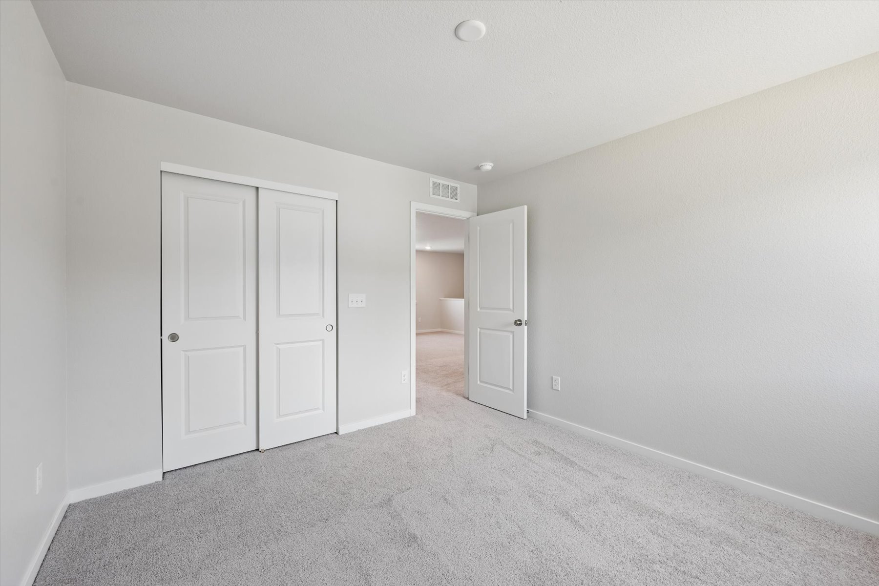 A hallway with white doors.