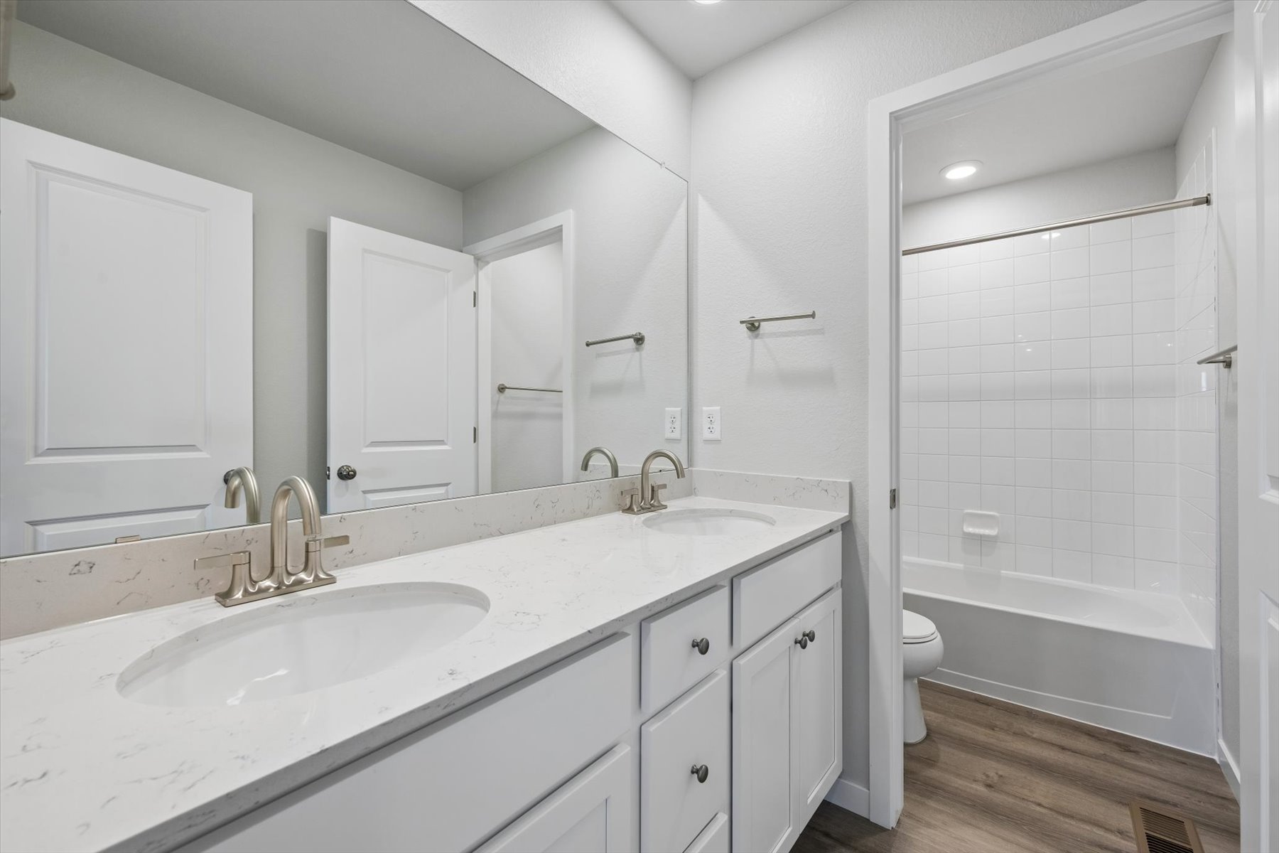 A bathroom with a tub sink and toilet.