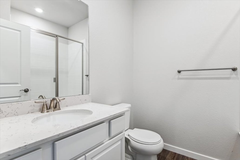 A bathroom with a sink toilet and shower.