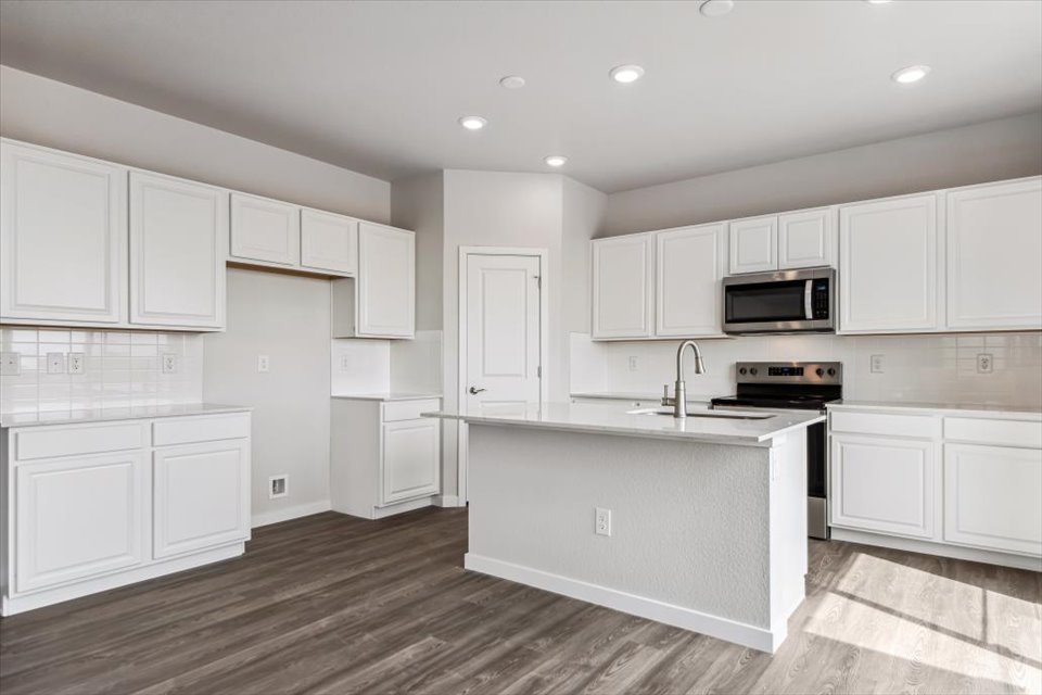 A kitchen with white cabinets.