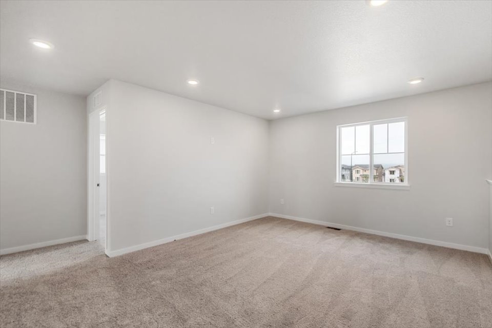 A room with a window and a carpet.