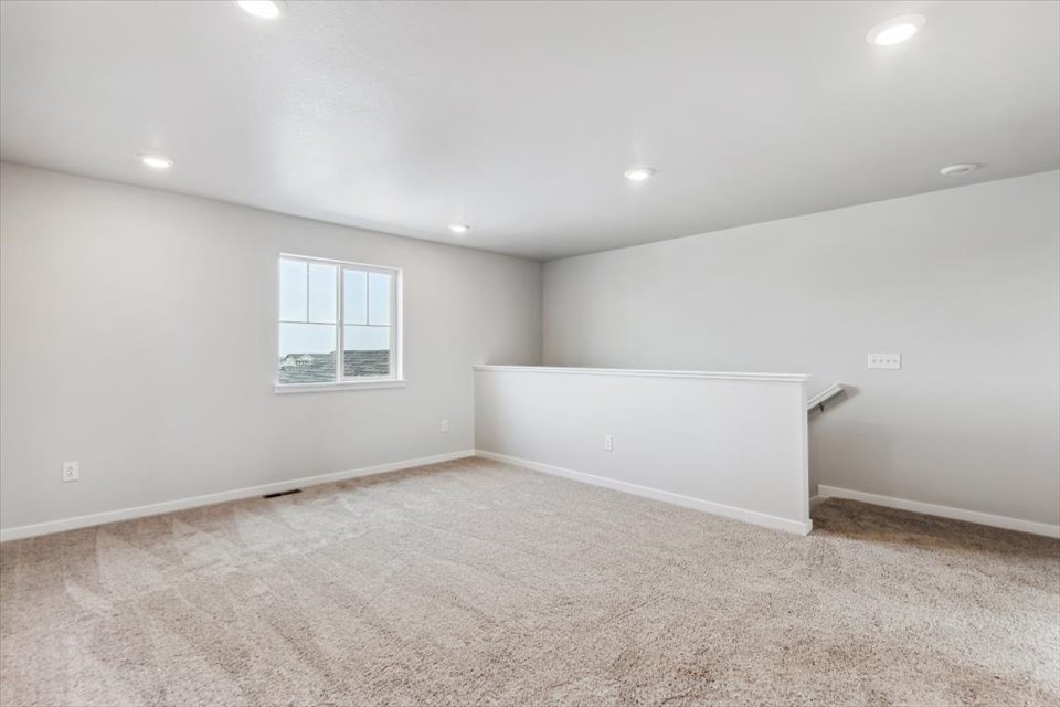 A room with a window and a carpet.